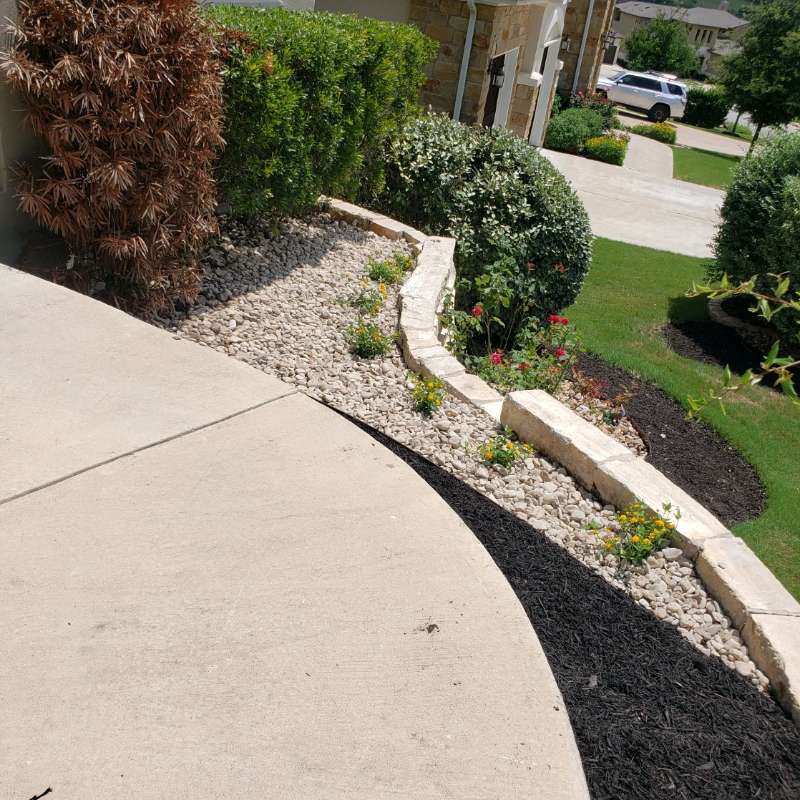 Front walkway with mulched beds and stone edging